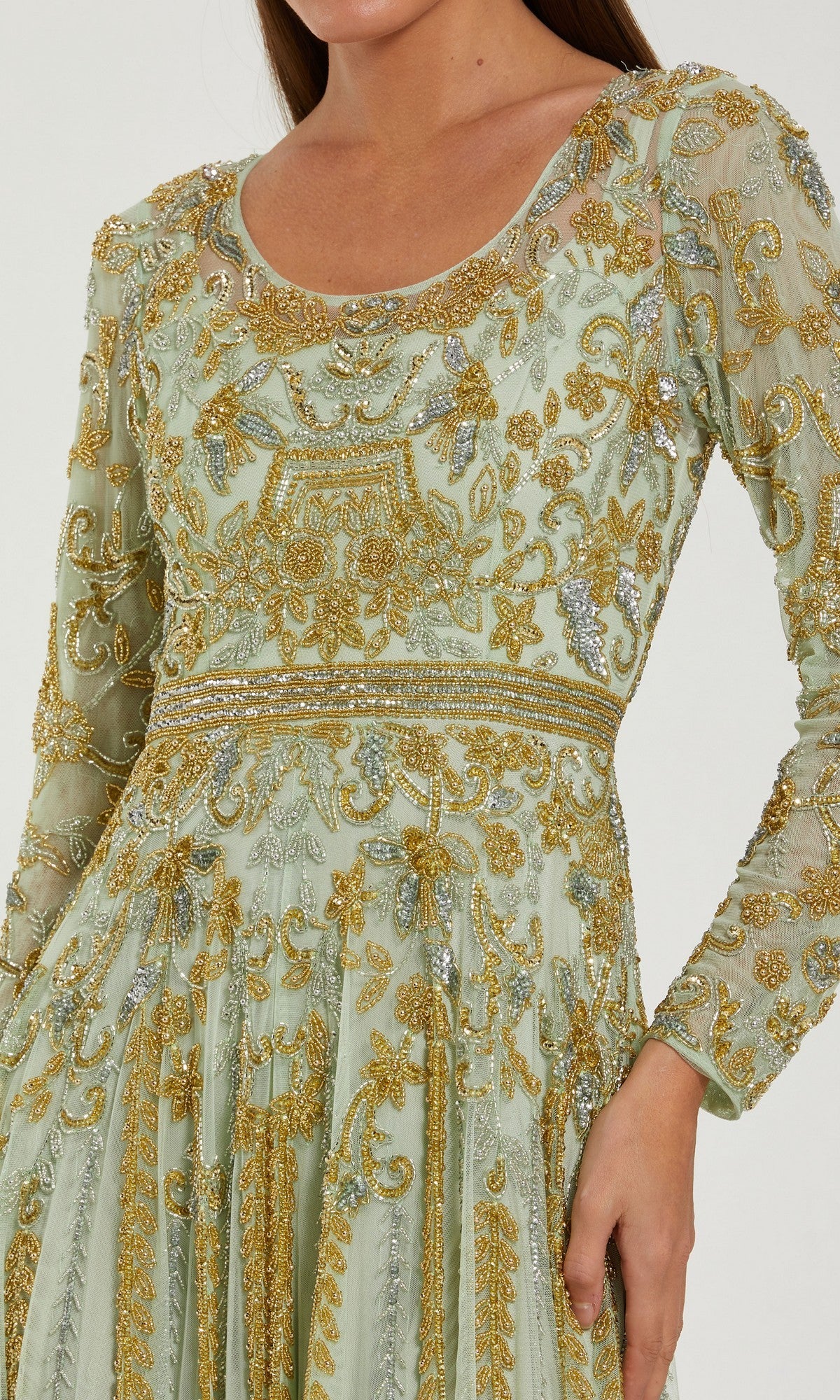 Wearing the Long Formal Dress: Mac Duggal 6201 in light green, which features intricate gold embroidery, gold beaded embellishments, long sleeves, and a fitted waist, creates an elegant and modest formal look.